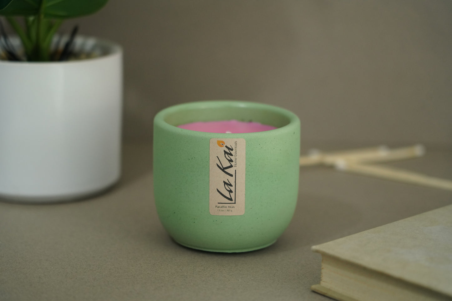 Green hand made concrete candle with pink wax